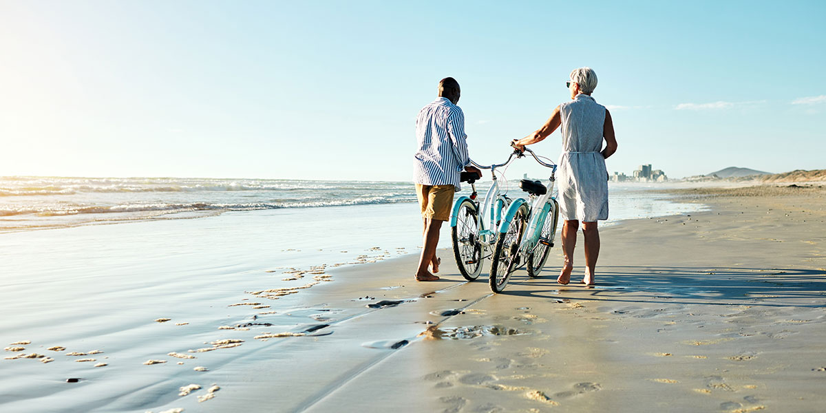 couple on beach with bikes